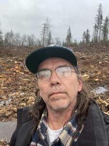 Zac Earley taking a selfie in front of a clear cut