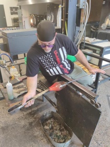 Bruce Nelson turning and shaping hot blown glass into a vase