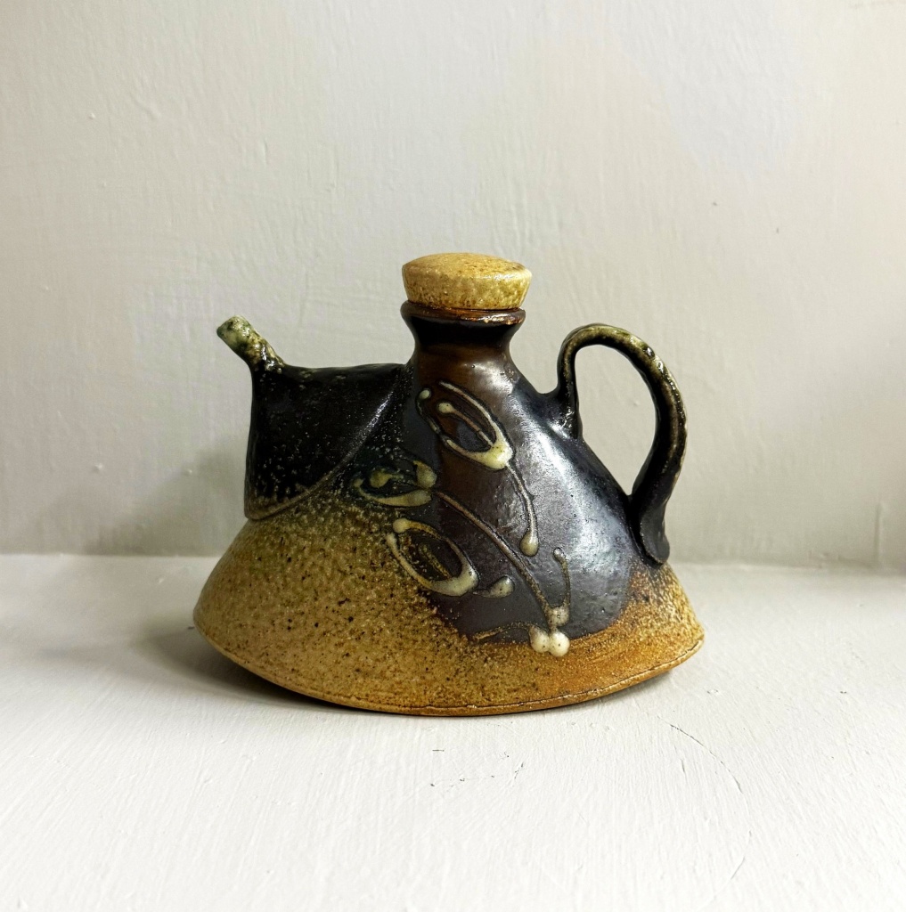 ceramic brown-glazed rocking pourer with lid and slim spout