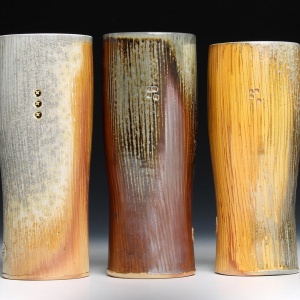 three tall yellow and earth tone brown tall goblets with vertical striations
