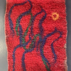 felted red tapestry with blue whispy vertical lines
