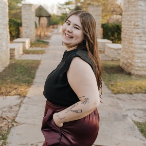 sideview of a woman with long hair smiling