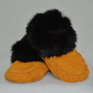 Tan leather moccasin pair with black fur