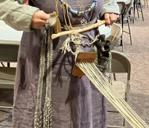 Viking woman holding backstrap loom