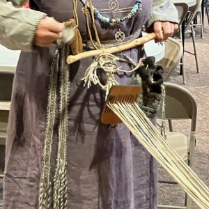 Viking woman holding backstrap loom
